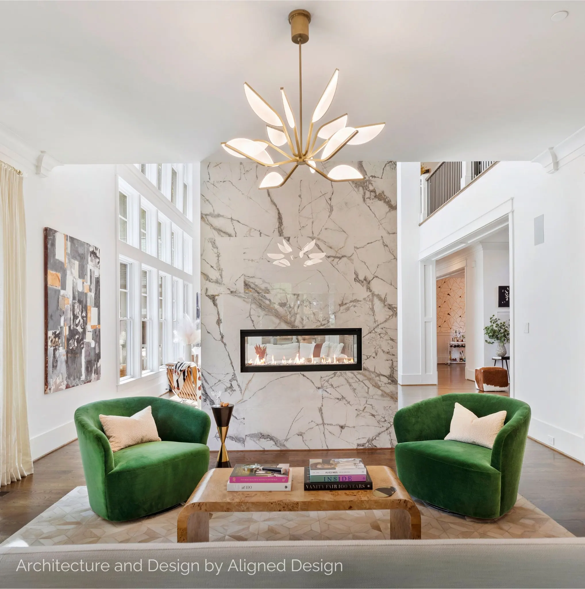 Living room with marble fireplace and emerald chairs for Aligned Design